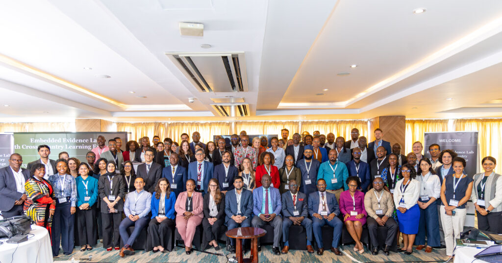 A large group of people posing for a photo in three rows.